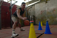 Male basketball sport training with BlazePods on cones