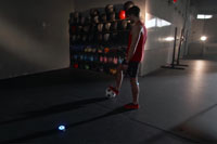 Male uses fitness tech BlazePod wireless touch sensors for football soccer training