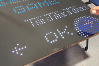 Close-up of Diplik Bit-Pong table tennis highlighting the digital game menu at event expo