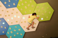 Girl active with GlowHolds interactive climbing wall system