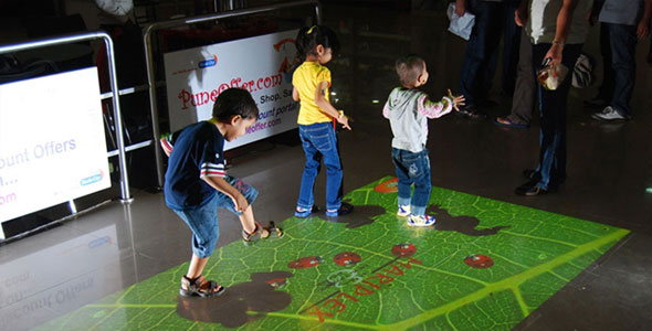 Little kids play with interactive projector game system